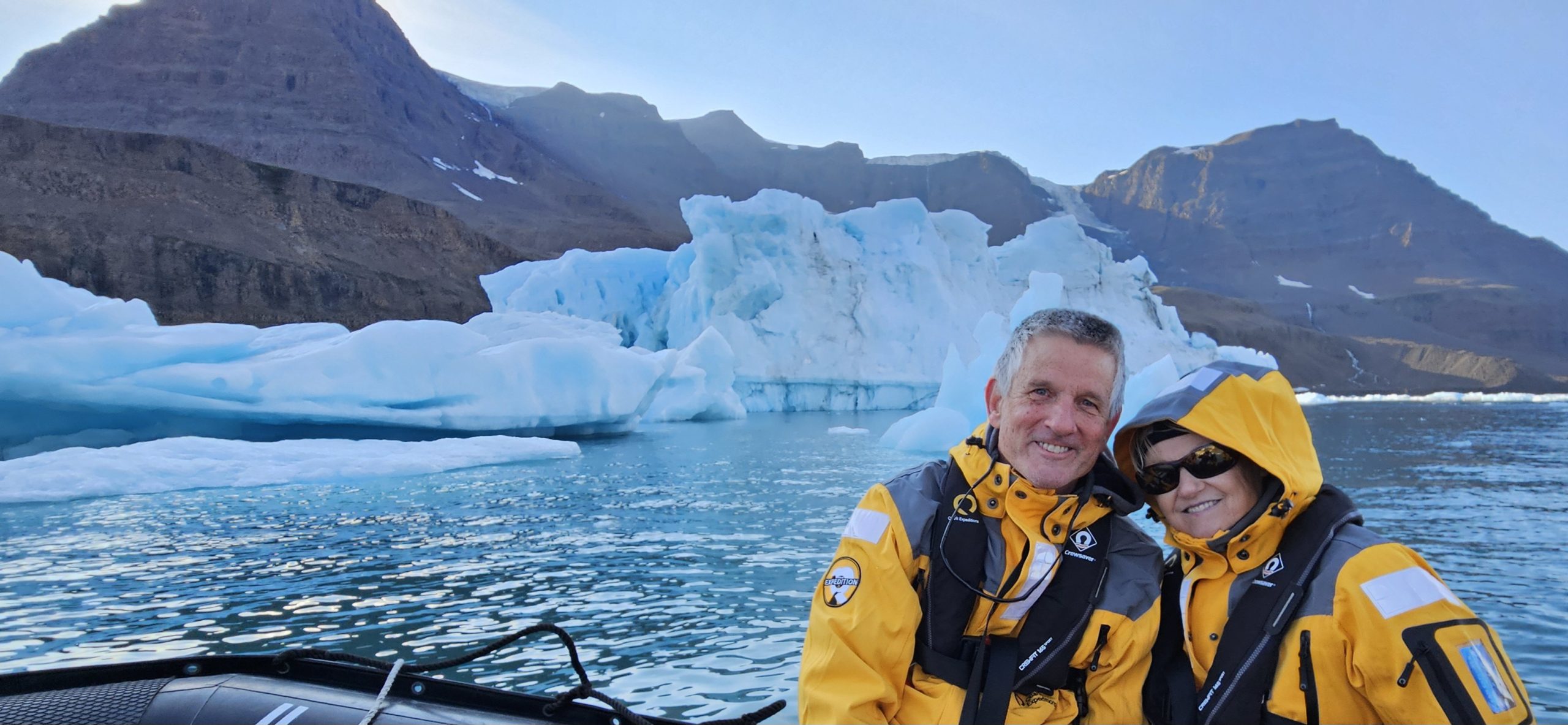 Clients on a Zodiac excursion near a Greenland glacier