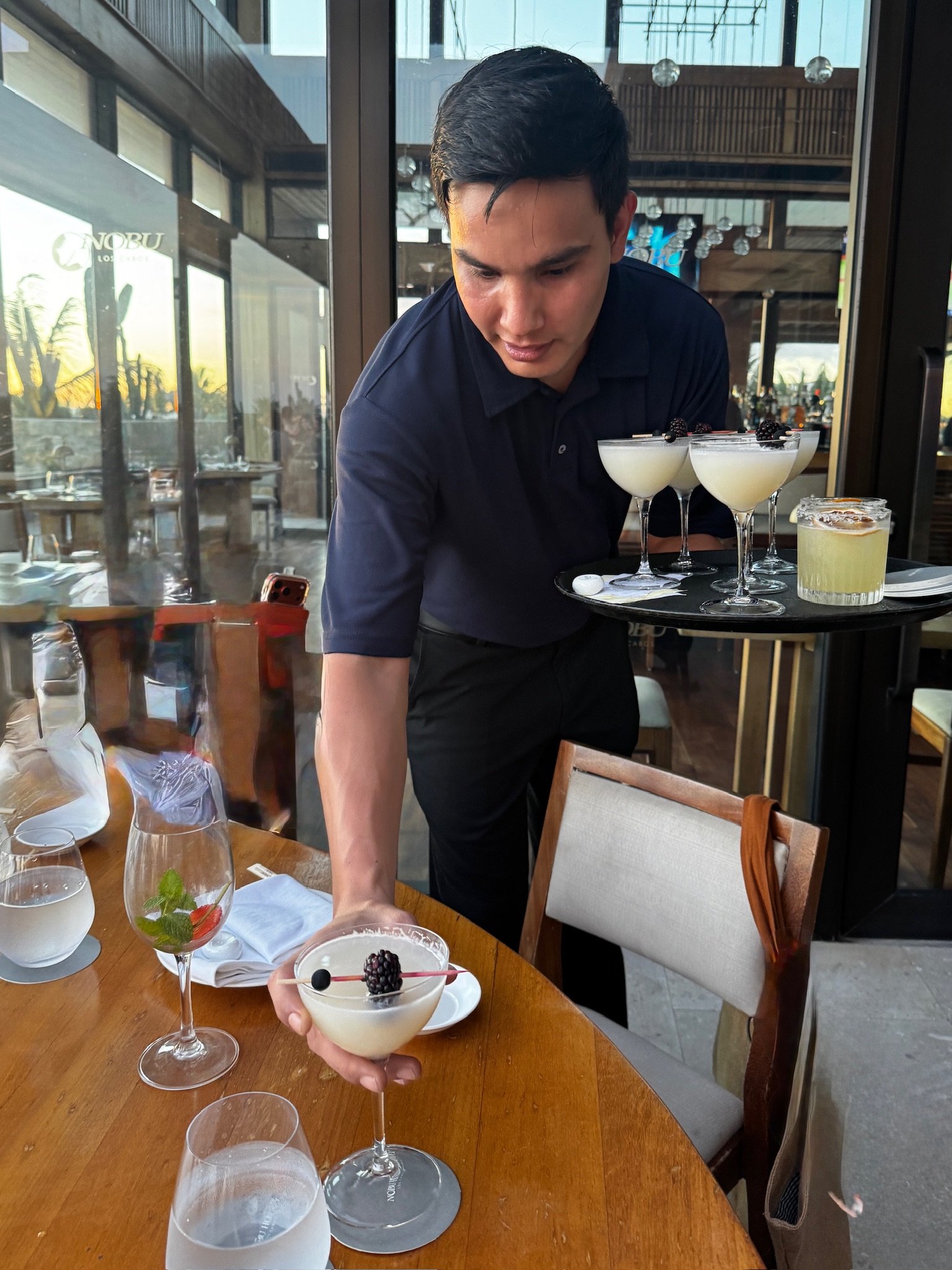 Server bringing drinks at Nobu Los Cabos